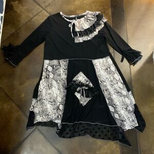 Ruffles and Mudpies brand top. Black and snake print. Size Medium